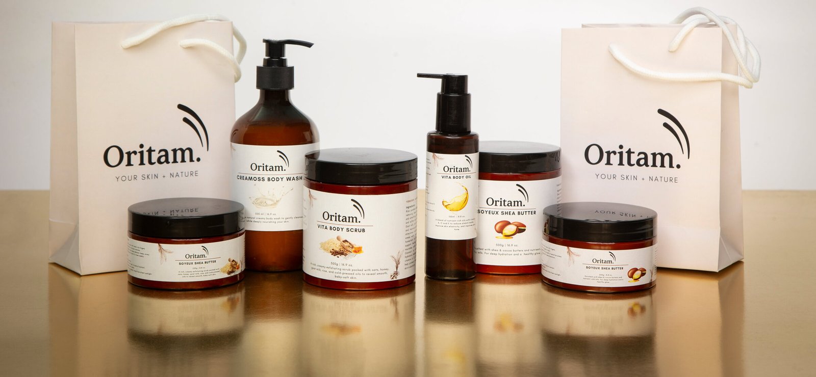 The full Oritam Naturals product line displayed on a golden table